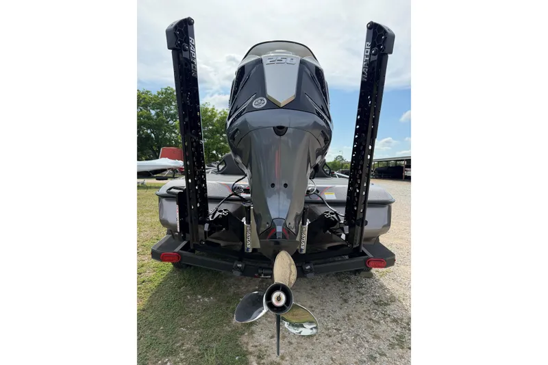 Slide: The Image of 2026 Skeeter ZXE21 boat rear view with powerful outboard motor and dual power poles. - 7