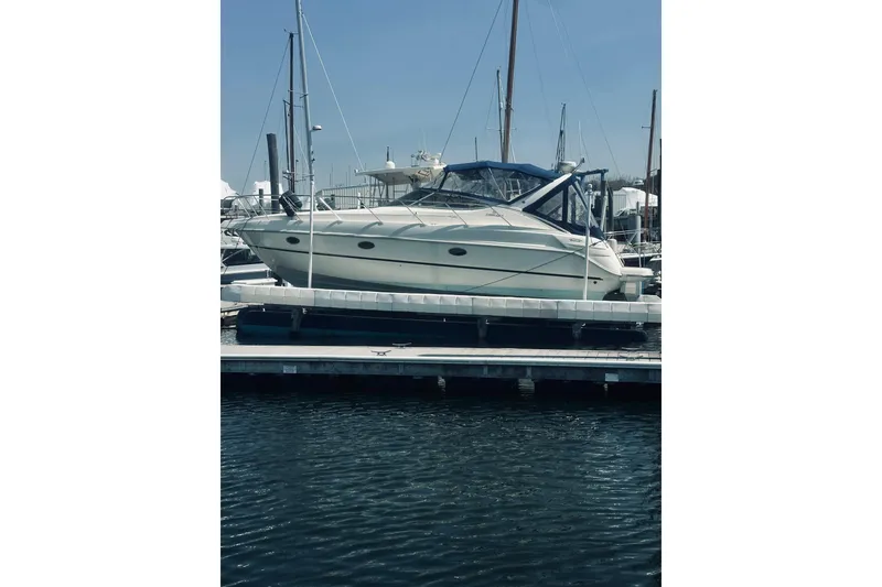 The Image of 1999 Cranchi Endurance 39 yacht docked at marina under clear blue sky. - 0