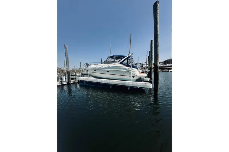 Slide: The Image of 1999 Cranchi Endurance 39 yacht docked at marina under clear blue sky. - 1