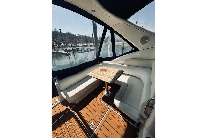 Slide: The Image of Interior of 1999 Cranchi Endurance 39 yacht with wooden table and white seating. - 10