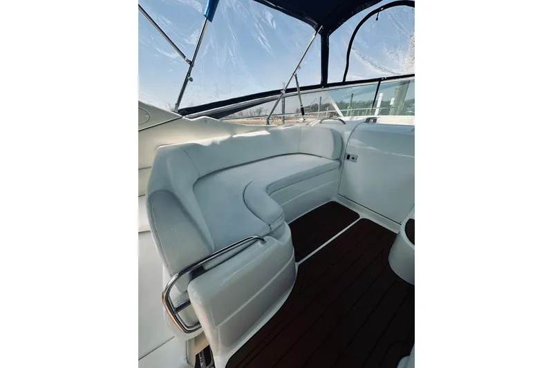 Slide: The Image of Interior of 1999 Cranchi Endurance 39 yacht with white seating and wooden flooring. - 11