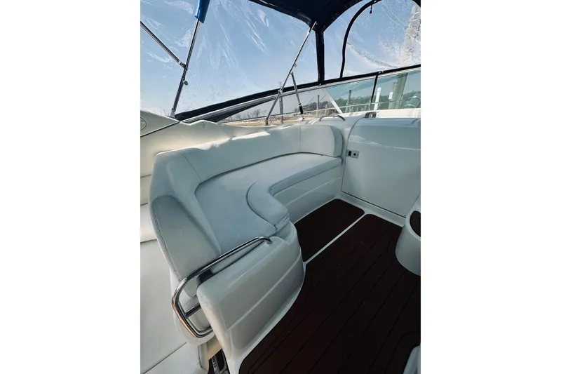 Slide: The Image of Interior of 1999 Cranchi Endurance 39 yacht with white seating and wooden flooring. - 12