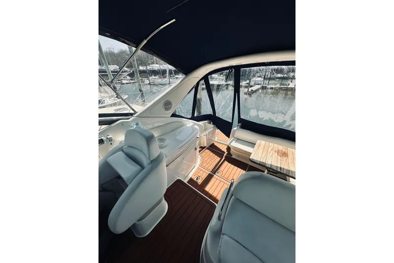 Slide: The Image of Interior view of 1999 Cranchi Endurance 39 yacht with seating and helm, docked at marina. - 15