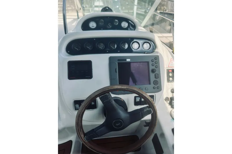 Slide: The Image of Cockpit of 1999 Cranchi Endurance 39 with steering wheel and navigation controls. - 19