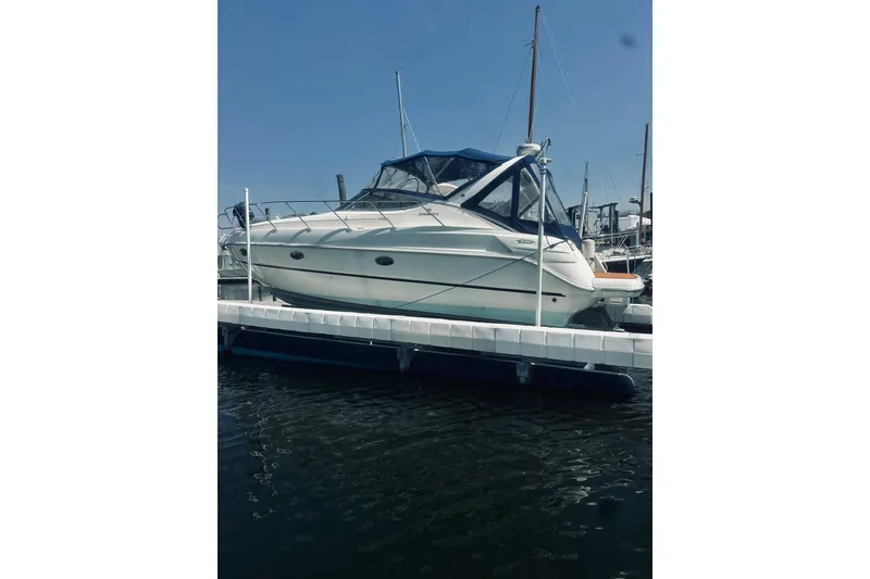 Slide: The Image of 1999 Cranchi Endurance 39 yacht docked at marina under clear blue sky. - 2