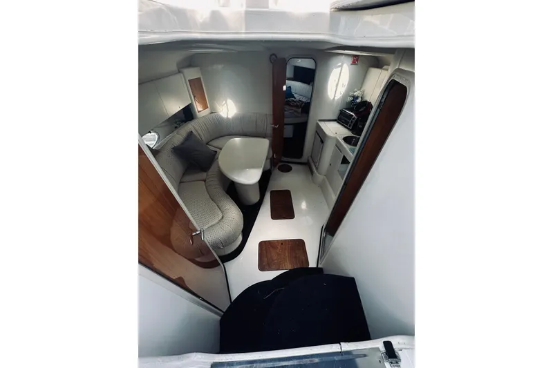 Slide: The Image of 1999 Cranchi Endurance 39 yacht interior with cozy seating and compact kitchen area. - 22