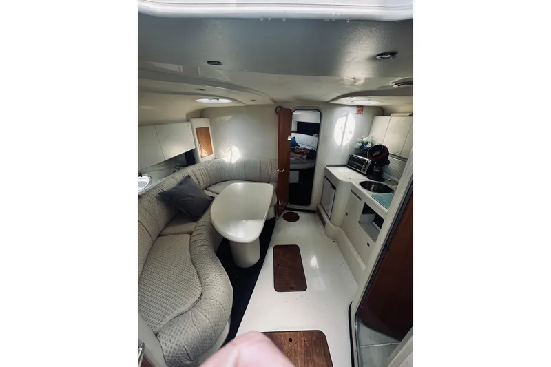 Slide: The Image of Interior of 1999 Cranchi Endurance 39 yacht with cozy seating and compact kitchen area. - 23