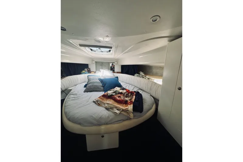 Slide: The Image of Cozy cabin interior of 1999 Cranchi Endurance 39 yacht with round bed and skylight. - 24