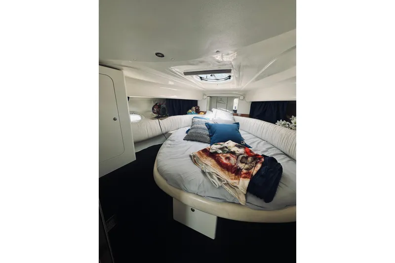Slide: The Image of Interior cabin of 1999 Cranchi Endurance 39 with cozy bedding and pillows. - 25
