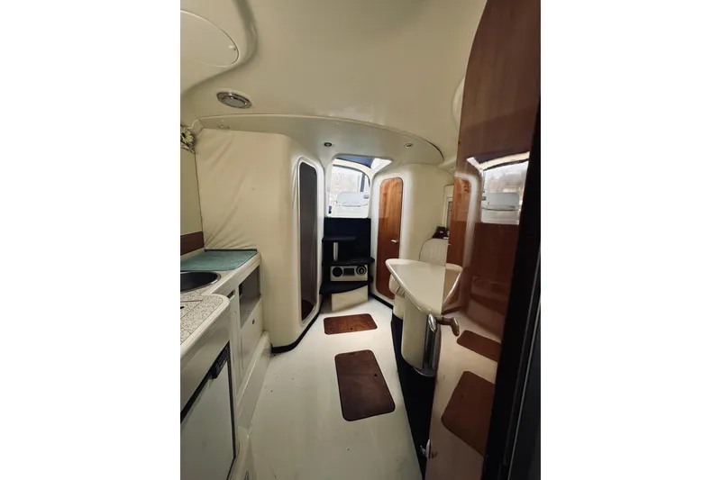 Slide: The Image of Interior of 1999 Cranchi Endurance 39 yacht, featuring compact kitchen and seating area. - 26
