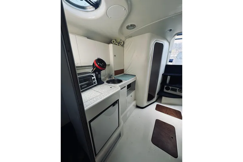 Slide: The Image of Interior of 1999 Cranchi Endurance 39 yacht featuring compact kitchen and modern amenities. - 27