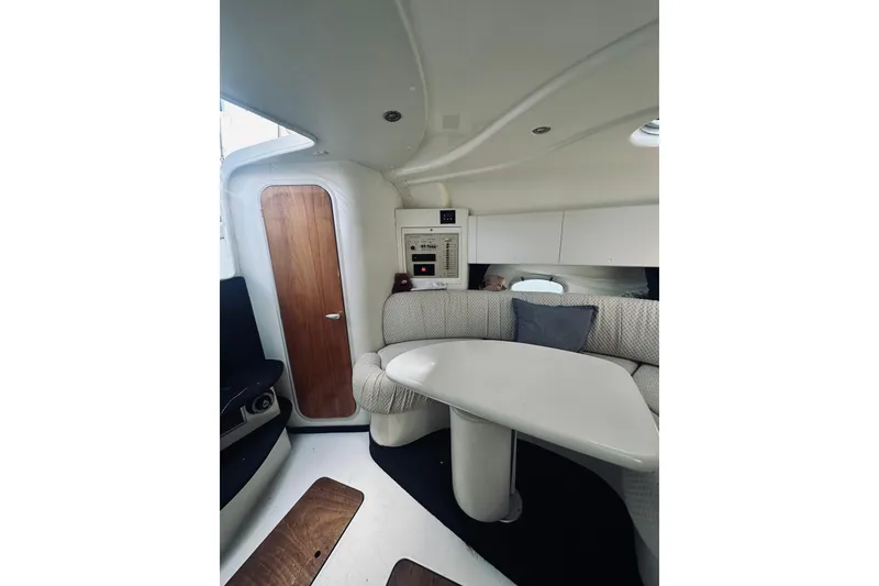 Slide: The Image of Interior of 1999 Cranchi Endurance 39 yacht with modern seating and wooden door. - 29