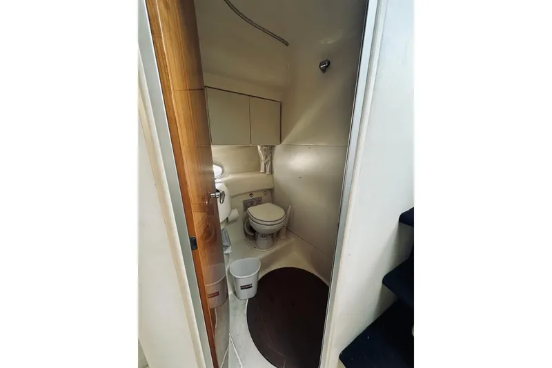 Slide: The Image of 1999 Cranchi Endurance 39 yacht bathroom interior with toilet and storage cabinets. - 30