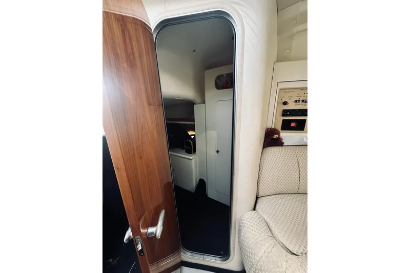Slide: The Image of Interior view of 1999 Cranchi Endurance 39 yacht, featuring wooden door and plush seating. - 32