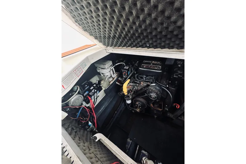 Slide: The Image of Engine compartment of 1999 Cranchi Zaffiro 34 boat with visible components and wiring. - 38