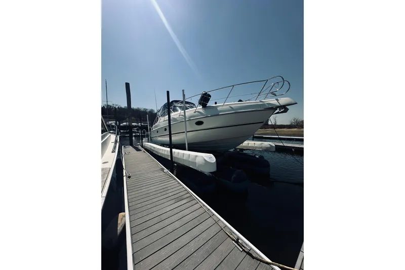 Slide: The Image of 1999 Cranchi Endurance 39 yacht docked at marina under clear blue sky. - 5