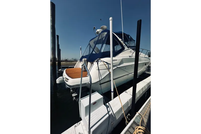 Slide: The Image of 1999 Cranchi Endurance 39 yacht docked at marina under clear blue sky. - 6
