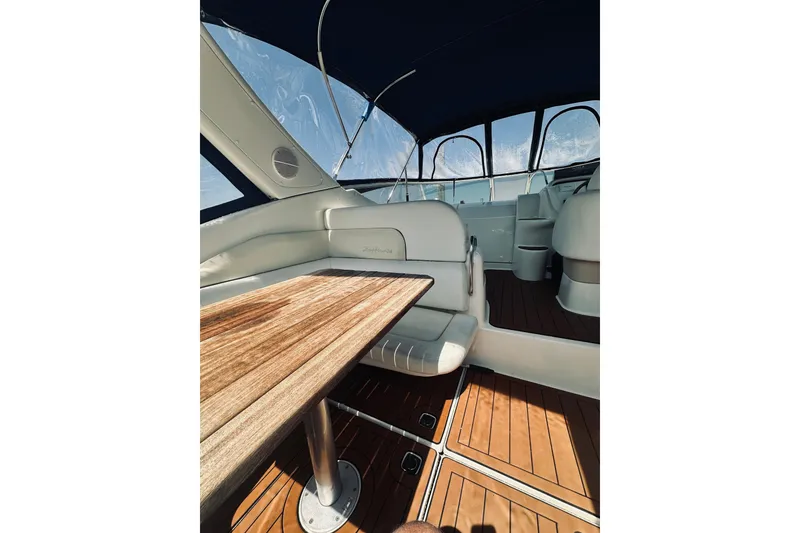 Slide: The Image of Interior of 1999 Cranchi Endurance 39 yacht with wooden table and seating. - 9