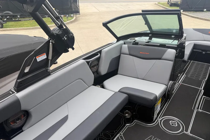 Slide: The Image of 2025 MasterCraft NXT23 boat interior with sleek gray seating and modern design. - 12