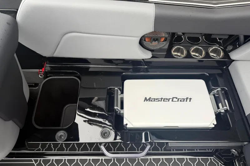 Slide: The Image of Interior of 2025 MasterCraft NXT23 boat featuring sleek seating and cup holders. - 19