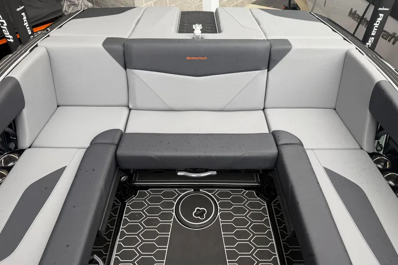 Slide: The Image of 2025 MasterCraft NXT23 boat interior with sleek gray seating and geometric flooring design. - 20