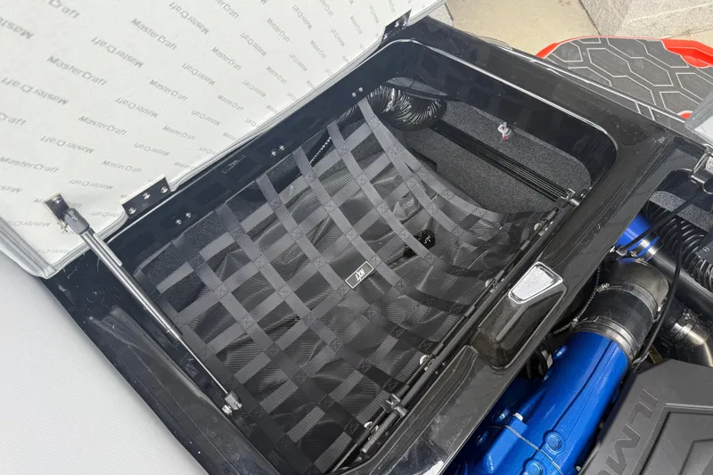 Slide: The Image of Open engine compartment of 2025 MasterCraft NXT23 boat, showcasing interior components. - 23
