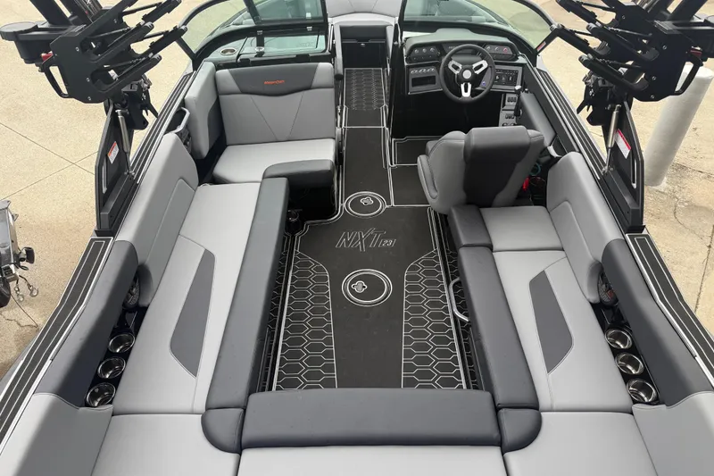 Slide: The Image of 2025 MasterCraft NXT23 boat interior with sleek seating and modern dashboard design. - 25