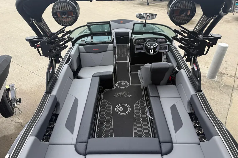 Slide: The Image of Interior view of a 2025 MasterCraft NXT23 boat with modern seating and sleek design. - 26