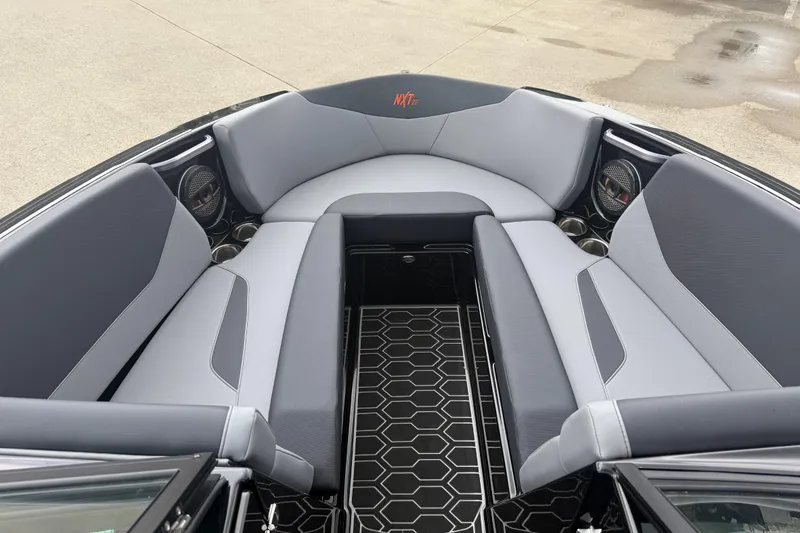 Slide: The Image of 2025 MasterCraft NXT23 boat interior with gray seating and hexagonal floor design. - 3