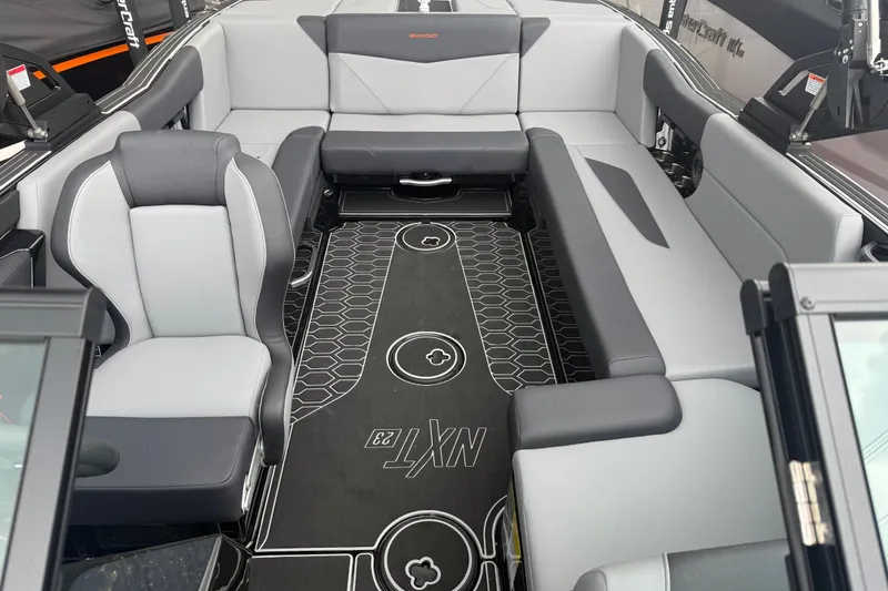 Slide: The Image of 2025 MasterCraft NXT23 boat interior with sleek gray seating and modern design. - 4