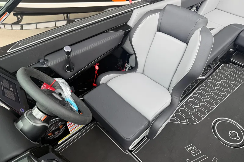 Slide: The Image of 2025 MasterCraft NXT23 boat interior with steering wheel and captain's seat. - 5