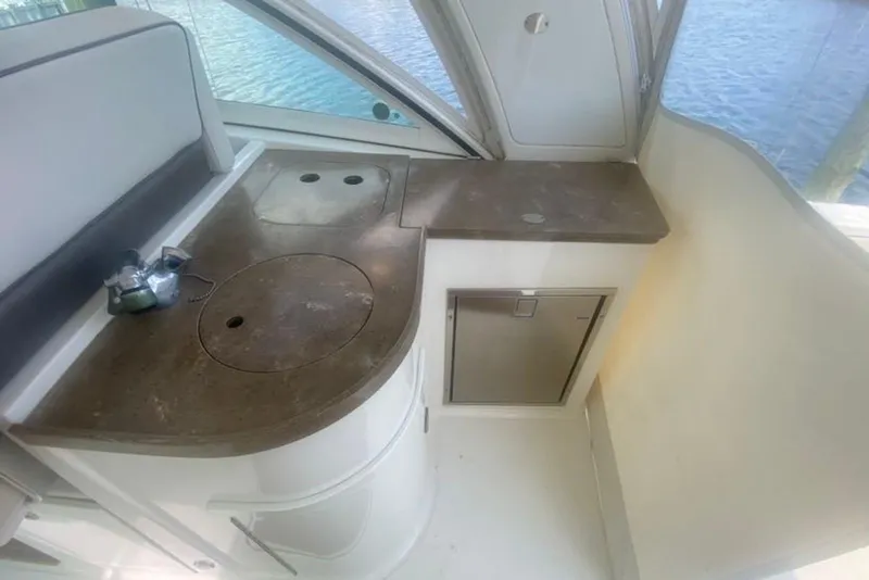 Slide: The Image of 2017 World Cat 320 DC boat interior with countertop and storage. - 4
