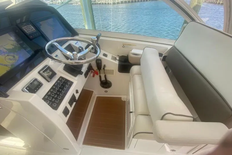 Slide: The Image of Cockpit of 2017 World Cat 320 DC boat with steering wheel and navigation screens. - 5