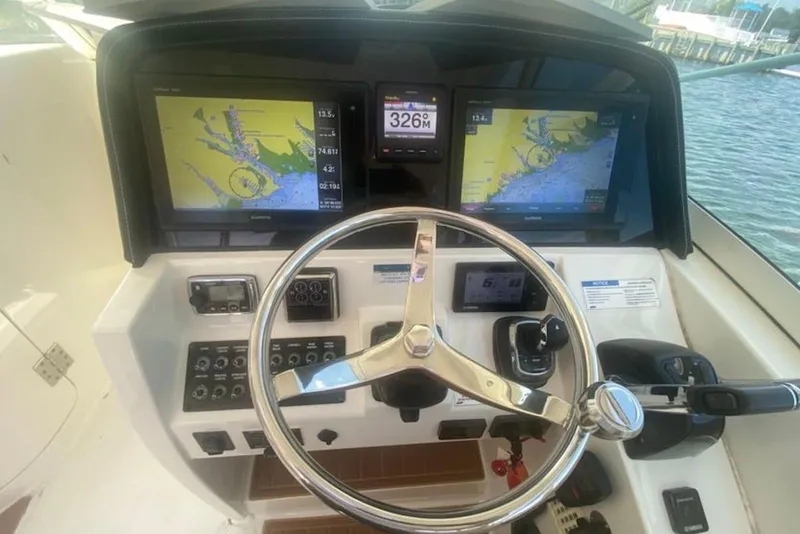 Slide: The Image of Helm of 2017 World Cat 320 DC with dual navigation screens and steering wheel. - 6