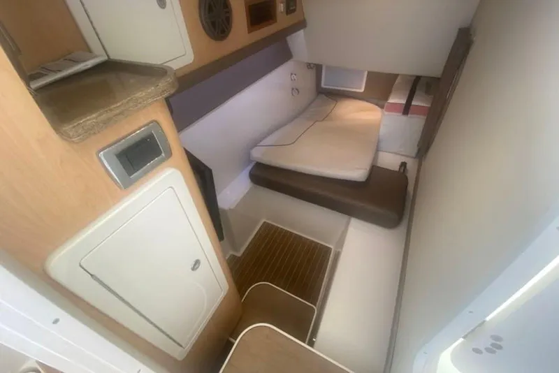 Slide: The Image of 2017 World Cat 320 DC cabin interior with bed, storage, and wooden flooring. - 8