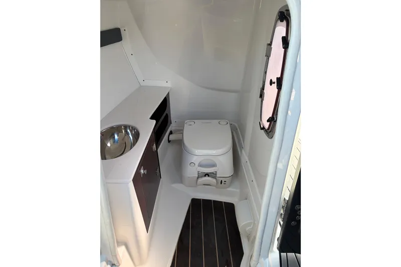Slide: The Image of Interior of 2019 Monterey 278SS Super Sport boat featuring compact marine toilet. - 18