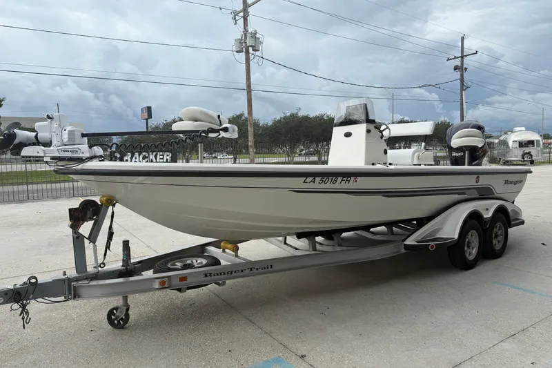Slide: The Image of 2007 Ranger 2200 Bay Ranger boat on trailer, parked outdoors under cloudy sky. - 7