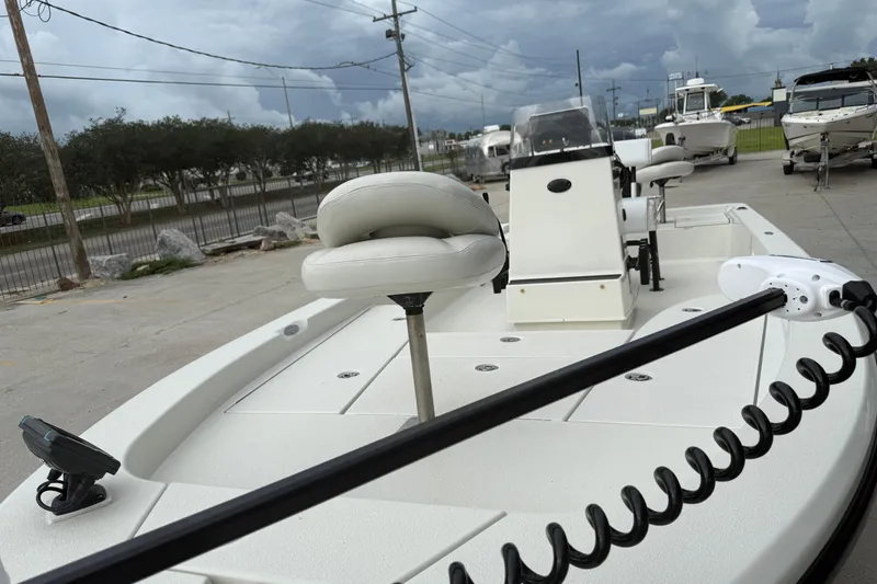 Slide: The Image of 2007 Ranger 2200 Bay Ranger boat with seating and control panel, parked outdoors. - 8