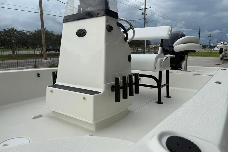 Slide: The Image of 2007 Ranger 2200 Bay Ranger boat interior with console and seating, under cloudy sky. - 9