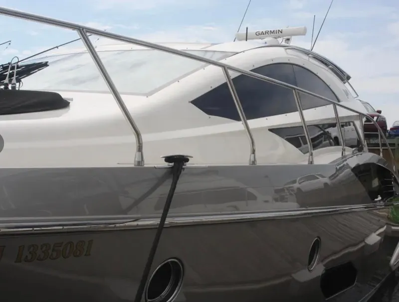 Slide: The Image of 2010 Marquis 500 SC yacht with sleek design and Garmin equipment, docked at marina. - 2