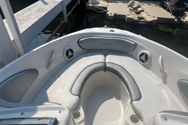 Slide: The Image of 2008 Sea Ray 205 Sport boat interior with cushioned seating and speakers. - 8