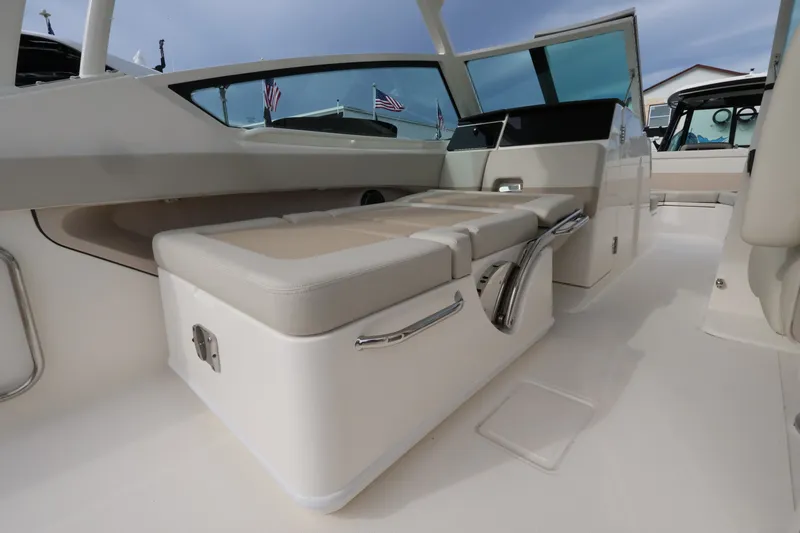 Slide: The Image of Interior of a Boston Whaler 280 Vantage with beige cushioned seating and modern design. - 14