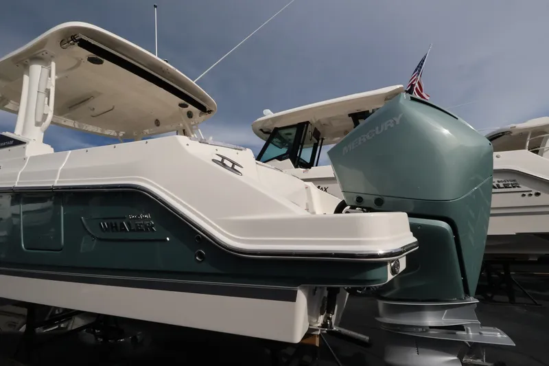 Slide: The Image of A 2027 Boston Whaler 280 Vantage with a large outboard motor. - 6