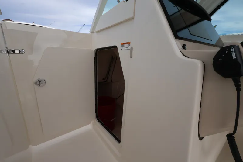 Slide: The Image of The 2027 Boston Whaler 280 Vantage features an open door to a storage compartment. - 29