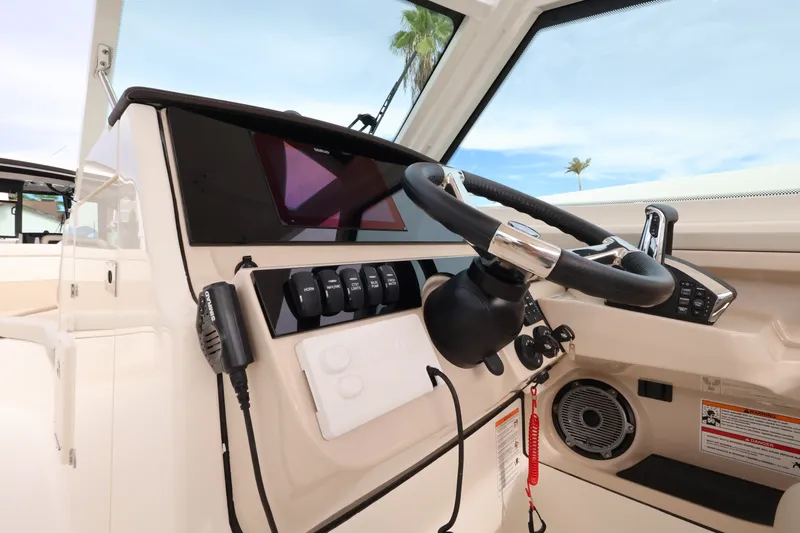 Slide: The Image of The image shows the helm of a Boston Whaler 280 Vantage boat with modern controls. - 22