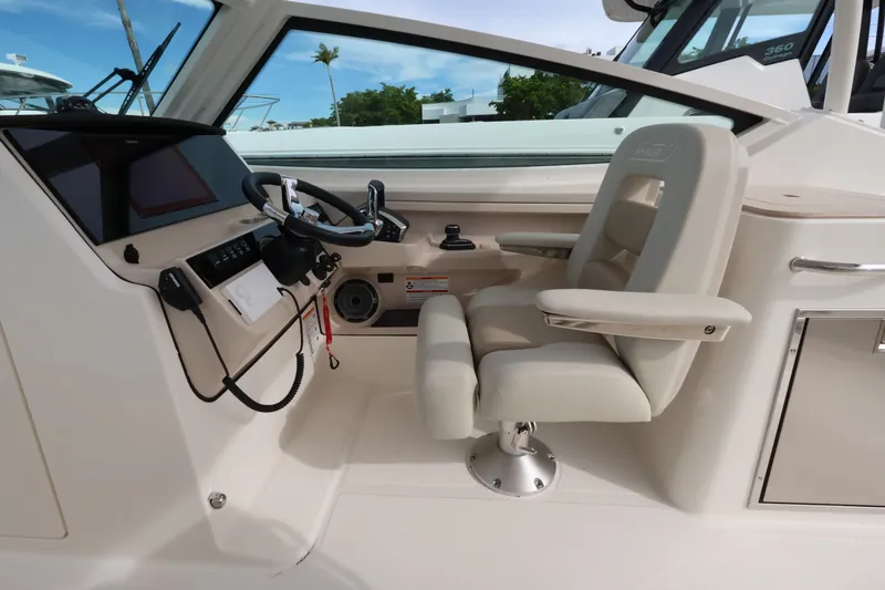 Slide: The Image of The image shows the cockpit of a 2027 Boston Whaler 280 Vantage with a comfortable helm seat. - 18
