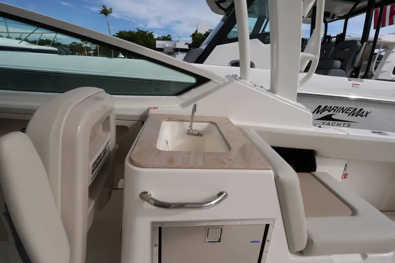 Slide: The Image of The 2027 Boston Whaler 280 Vantage features a sleek onboard kitchenette with a sink and storage. - 17