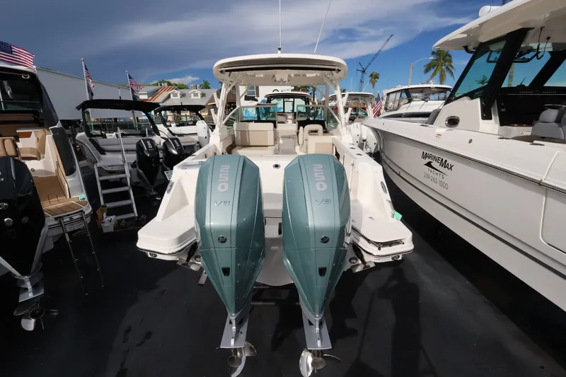 Slide: The Image of The image shows a Boston Whaler 280 Vantage boat with twin outboard engines at a marina. - 3