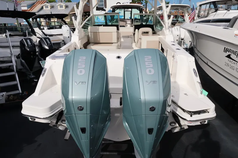Slide: The Image of 2027 Boston Whaler 280 Vantage with twin outboard engines at the dock. - 4