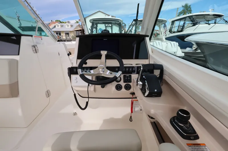 Slide: The Image of The cockpit of a 2027 Boston Whaler 280 Vantage with modern steering and instruments. - 20